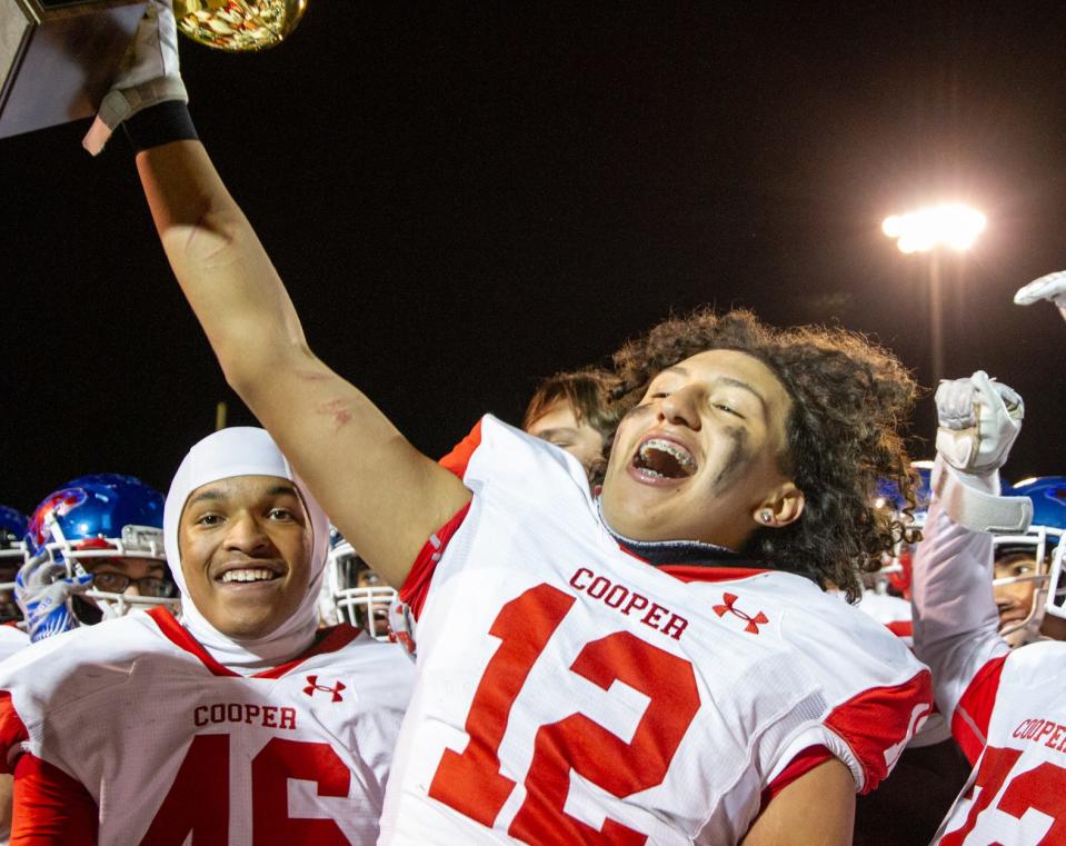 Cooper's Ryan Guevara celebrates with his teammates after defeating El Paso Chapin 42-27 in the Region I-5A Division II bi-district playoff game Friday in El Paso.