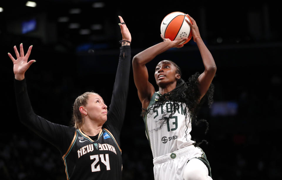 Seattle Storm center Ezi Magbegor (13) drives to the basket against New York Liberty forward Kylee Shook (24) during the first half of a WNBA basketball game Friday, Aug. 20, 2021, in New York. (AP Photo/Noah K. Murray)