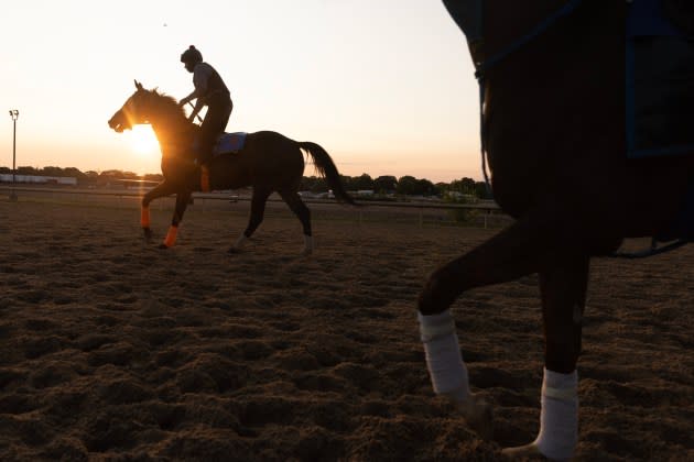 Exercise riders work out their mounts on the morning of the 2023 Belmont Stakes at Belmont Park racetrack in New York.  - Credit: Victor J. Blue/FX