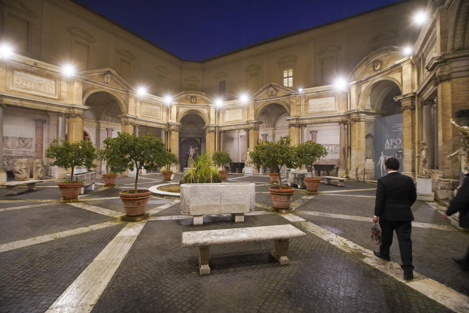 Gianni Crea, the Vatican Museums chief "Clavigero" key-keeper, walks through the octagonal courtyard on his way to open the museum's rooms and sections, the Vatican, Monday, Feb. 1, 2021. Crea is the “clavigero” of the Vatican Museums, the chief key-keeper whose job begins each morning at 5 a.m., opening the doors and turning on the lights through 7 kilometers of one of the world's greatest collections of art and antiquities. The Associated Press followed Crea on his rounds the first day the museum reopened to the public, joining him in the underground “bunker” where the 2,797 keys to the Vatican treasures are kept in wall safes overnight. (AP Photo/Andrew Medichini)