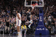 Fans react to a dunk by Dallas Mavericks center Dereck Lively II (2) as Oklahoma City Thunder's Aaron Wiggins, front, looks away during the second half in Game 3 of an NBA basketball second-round playoff series, Saturday, May 11, 2024, in Dallas. (AP Photo/Tony Gutierrez)