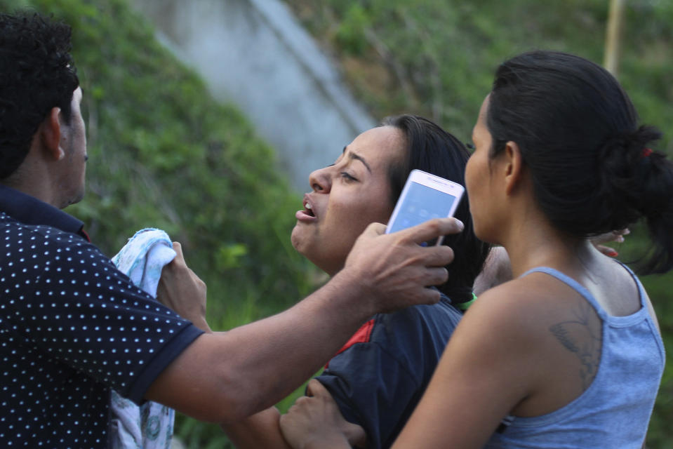 Relatives of prisoners demand more information from authorities, outside the Anisio Jobim Prison Complex in Manaus, Amazonas state, Brazil, Monday, May 27, 2019. Brazilian authorities said 42 inmates were killed at three different prisons in the capital of the northern state of Amazonas, a day after 15 prisoners died in a riot at a fourth prison in the city. (AP Photo/Edmar Barros)