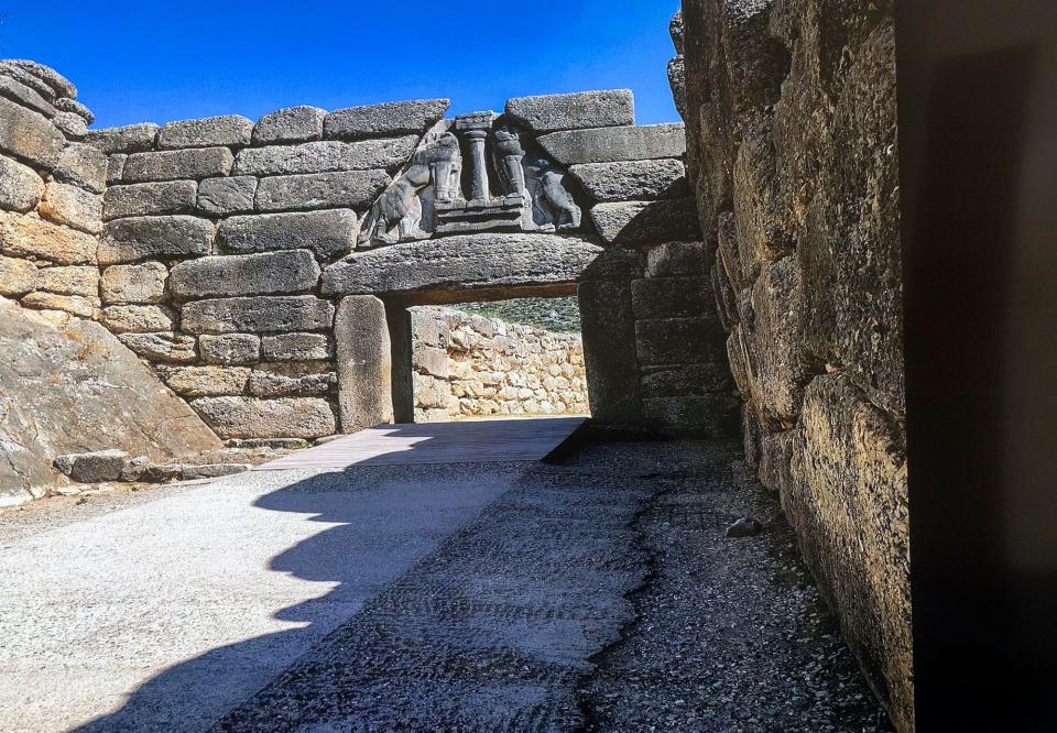 An ancient Mycenaean archway explored by Joe Wagman. The entrance to the walled city-state was built for defensive purposes. When invaders would approach, the Mycenaeans stationed warriors atop the walls surrounding the entrance.