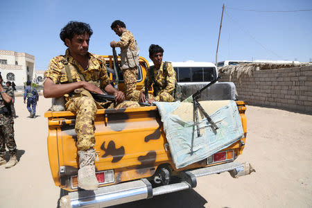 Pro-government police troopers ride on the back of a patrol truck in the northern city of Marib, Yemen November 4, 2017. REUTERS/Ali Owidha