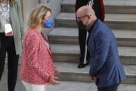 Italian Minister for Ecological Transition Roberto Cingolani, right, welcomes welcomes his French homologue Barbara Pompili as she arrives at Palazzo Reale in Naples, Italy, Thursday, July 22, 2021, to take part in a G20 meeting on environment, climate and energy. (AP Photo/Salvatore Laporta)