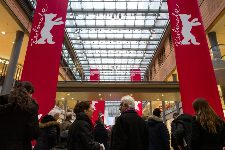 People queue up in front of a booth selling tickets for the Berlinale Film Festival, in a shopping mall in Berlin on February 8, 2016