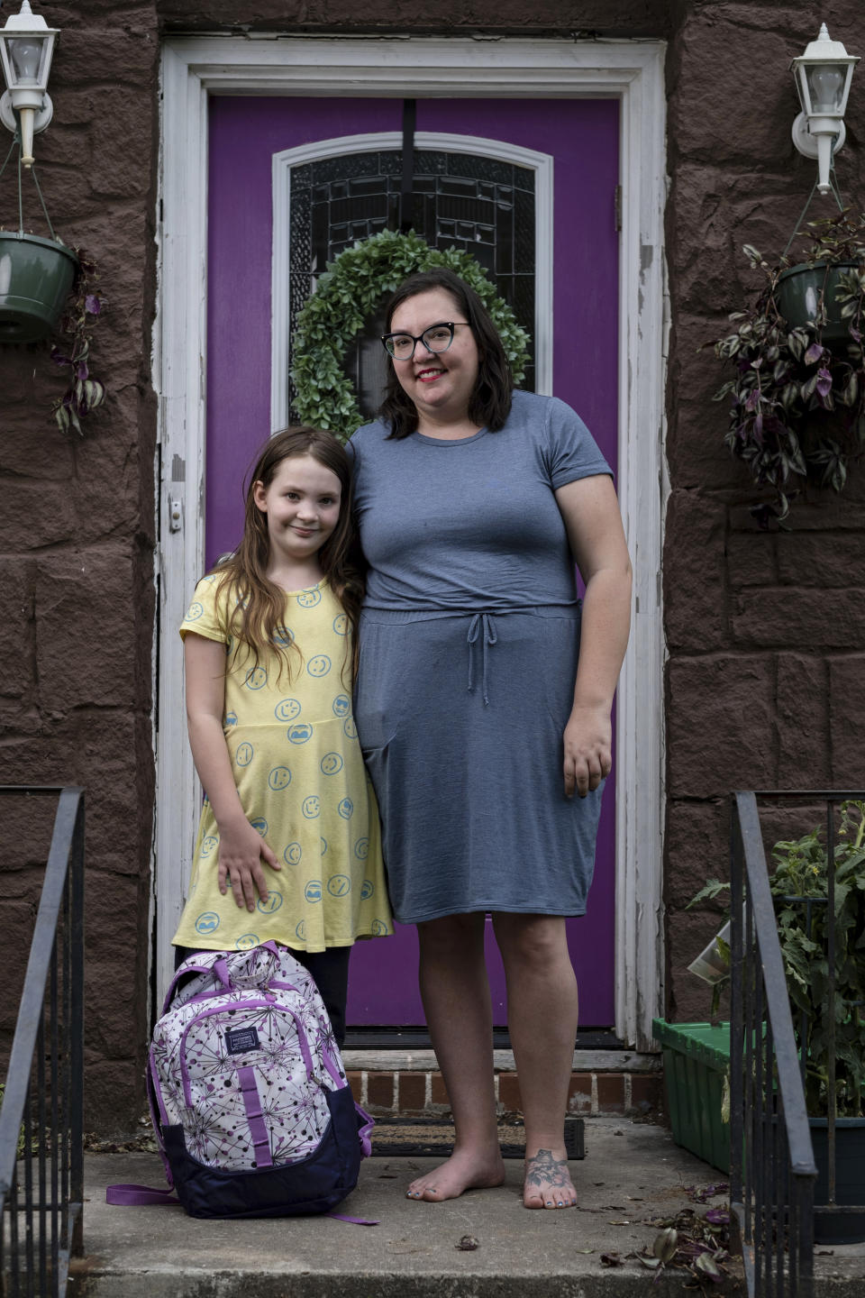 Abby Norman, right, and her 9-year-old daughter Priscilla Norman, left, pose at the family's home in Decatur, Ga., Tuesday, May 18, 2021. Norman said Priscilla was in tears the first morning of school testing because she felt pressure to do well, but didn't feel prepared after remote learning. (AP Photo/Ben Gray)