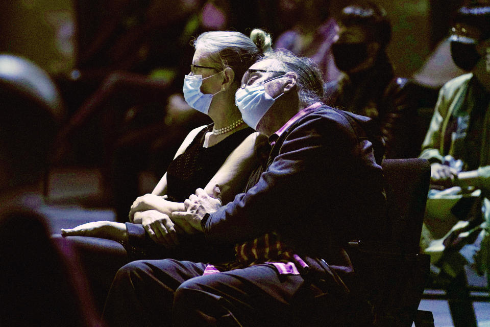 A man and woman listen to a concert by the New York Philharmonic, which performed before a live audience for the first time since March 10, 2020, at The Shed in Hudson Yards, Wednesday, April 14, 2021, in New York. (AP Photo/Kathy Willens)