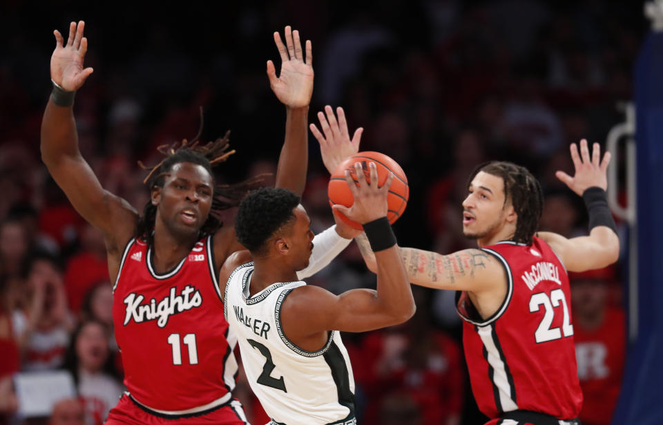 Rutgers center Clifford Omoruyi (11) and guard Caleb McConnell (22) defend against Michigan State guard Tyson Walker (2) during the first half of an NCAA college basketball game in New York, Saturday, Feb. 4, 2023. (AP Photo/Noah K. Murray)