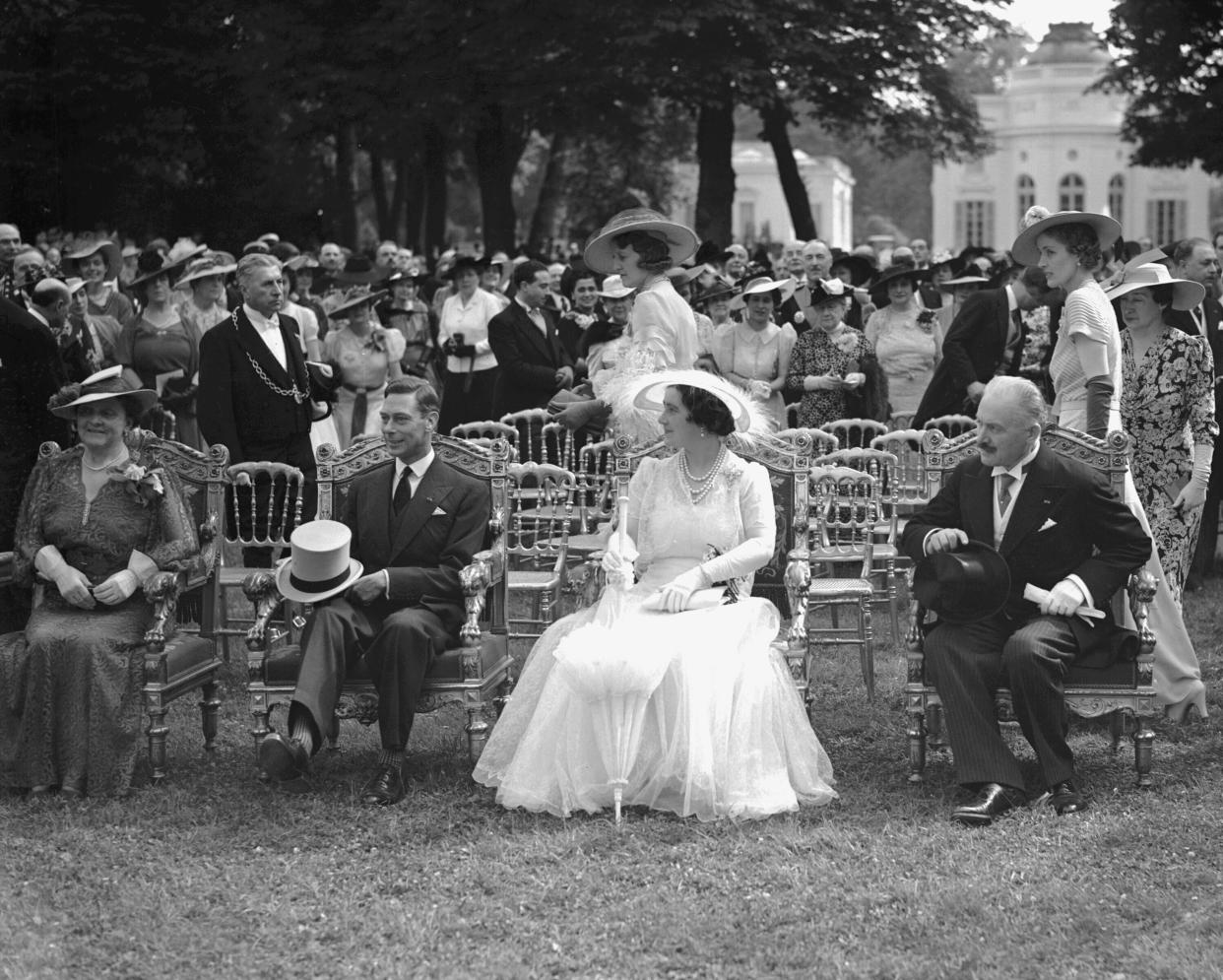 Britain's King George VI and Queen Elizabeth, centre, sit with France's President Albert Lebrun, right, and his wife Mme. Lebrun, left, by the lake at Bagatelle, Paris, France, July 20, 1938, (Copyright 2023 The Associated Press. All rights reserved.)