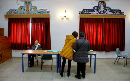 Women take their ballots before casting their vote for the Andalusian regional elections in Seville, Spain, December 2, 2018. REUTERS/Marcelo del Pozo