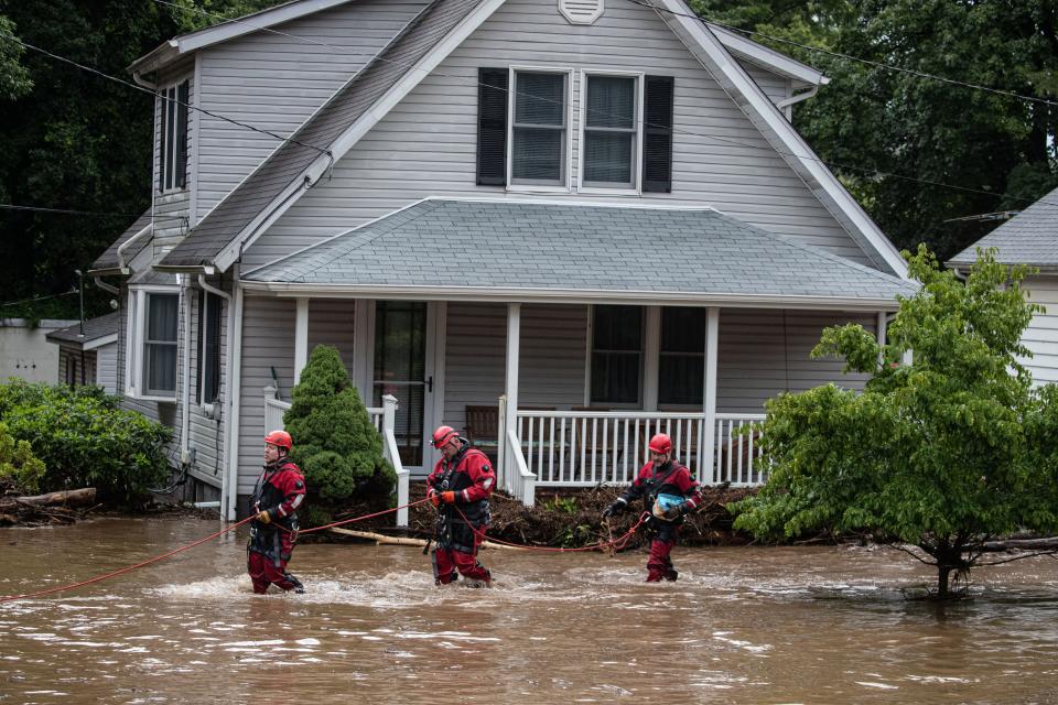 Emergency personnel work at the scene of flooded homes  on Lowland Hill Rd. in Stony Point, New York, July 9, 2023.