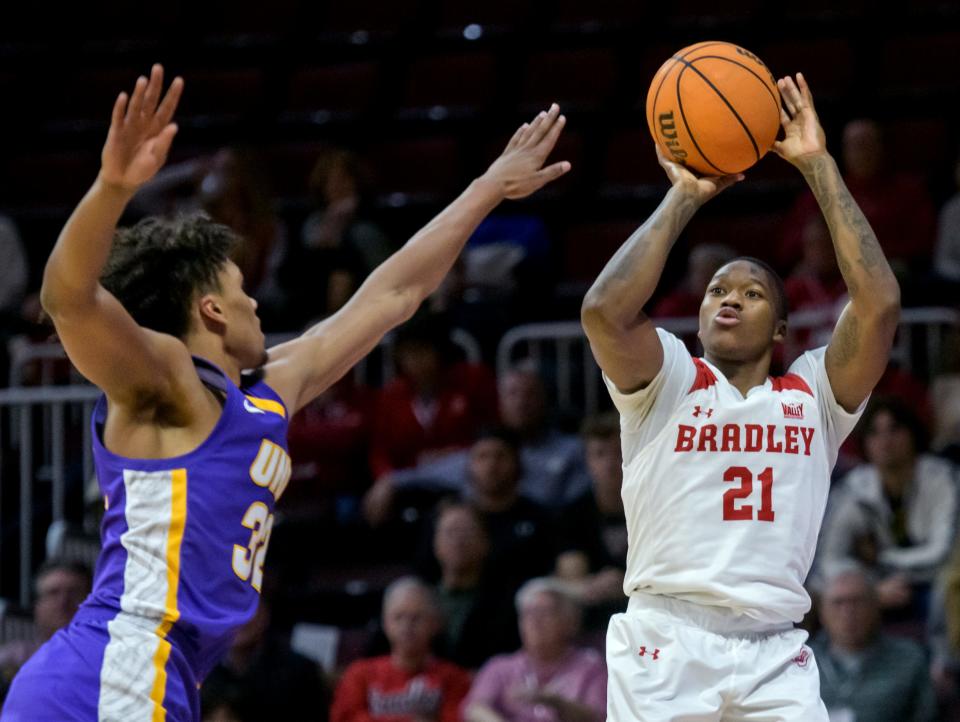 Bradley's Duke Deen (21) puts up a three-pointer over Northern Iowa's Tytan Anderson in the second half of their Missouri Valley Conference basketball opener Wednesday, Nov. 30, 2022 at Carver Arena. The Braves defeated the Panthers 68-53.