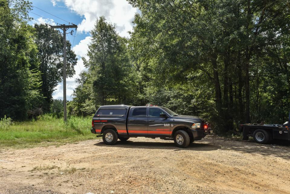 An emergency services vehicle blocks the entrance outside of an oil well storage facility after an oil tank explosion was reported in Flora, Miss., Friday, July 29, 2022. Six people were seriously injured, two of whom were airlifted to local hospitals.