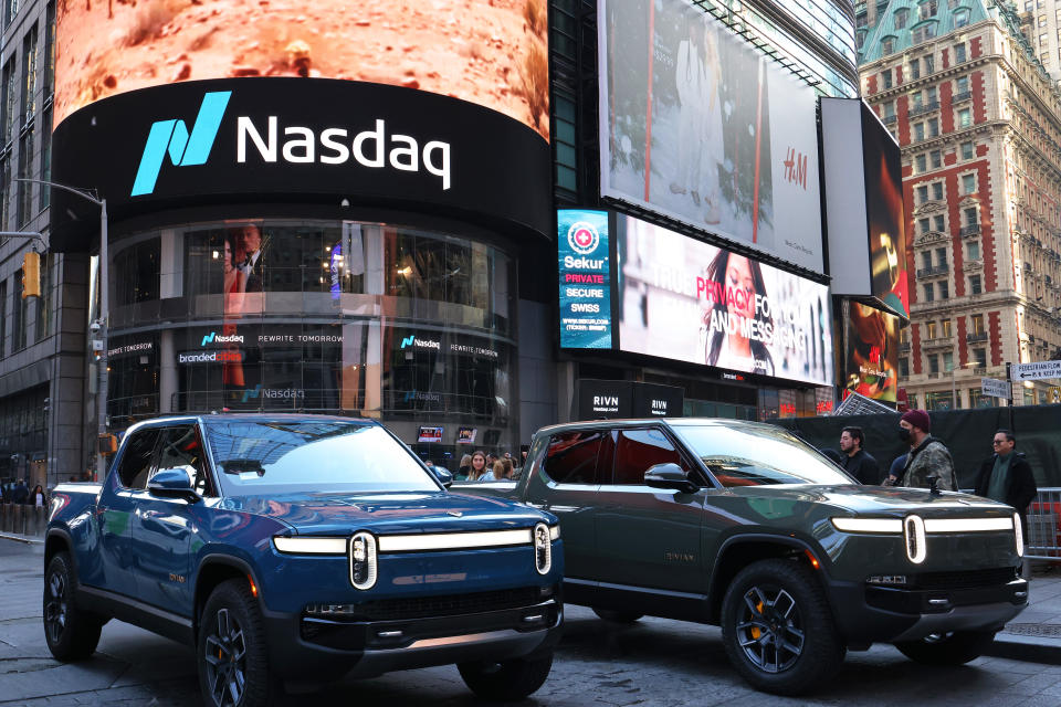 NEW YORK, NEW YORK - NOVEMBER 10: Rivian electric trucks are seen parked near the Nasdaq MarketSite building in Times Square on November 10, 2021 in New York City.  Rivian, an electric truck maker backed by Amazon and Ford, made its debut at Nasdaq going public with an IPO valued at close to $70 billion with 153,000,000 shares of Class A common stock at a public offering price of $78.00 per share. (Photo by Michael M. Santiago/Getty Images)