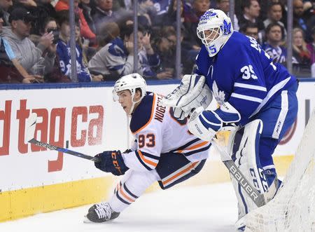 Dec 10, 2017; Toronto, Ontario, CAN; Edmonton Oilers forward Ryan Nugent-Hopkins (93) pursues the puck after it is cleared away by Toronto Maple Leafs goalie Curtis McElhinney (35) in the third period at Air Canada Centre. Mandatory Credit: Dan Hamilton-USA TODAY Sports