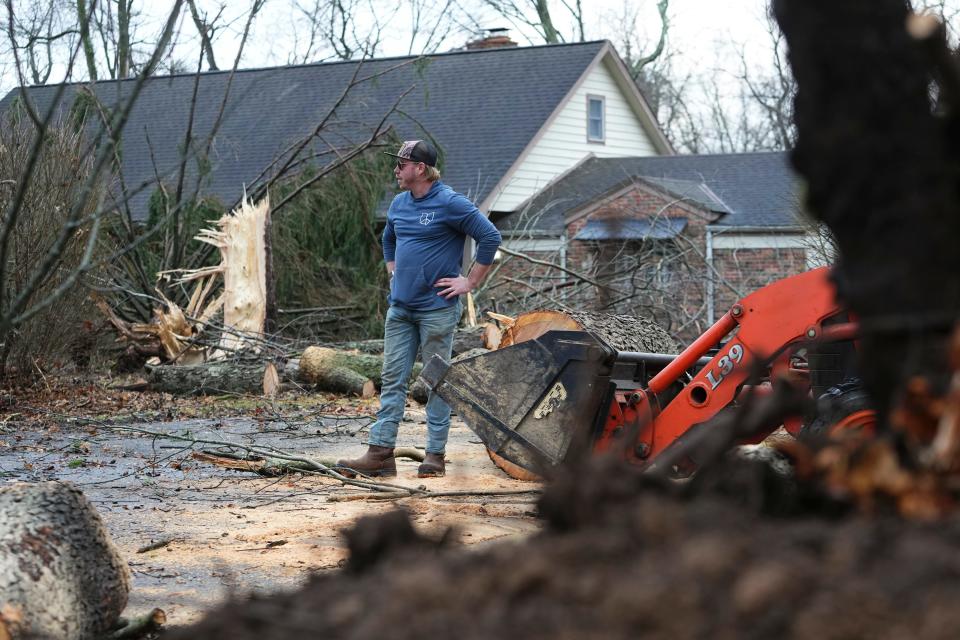 Dannie Devol assesses the damage while working to clear trees off his private road after a potential tornado touched down in the early morning.
(Credit: Adam Cairns/Columbus Dispatch)