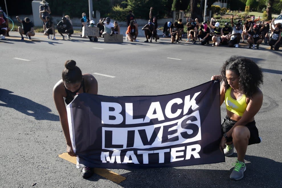 Protesters display a BLM banner (Associated Press)