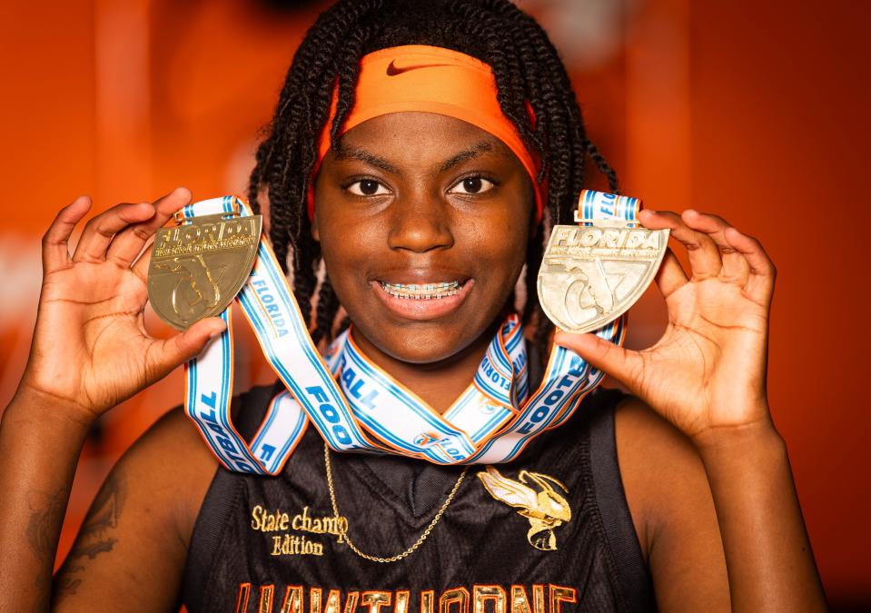 Hawthorne High School’s De'Mya Adams is this year’s Gainesville Sun Girls Basketball Player of the Year. Adams, 17 and a junior, plays both shooting and point guard for the Hornets. The team won the Basketball State Championship two years in a row and Adams shows off the two medals Thursday afternoon, April 11, 2024 at Hawthorne High School. [Doug Engle/Ocala Star Banner]2024