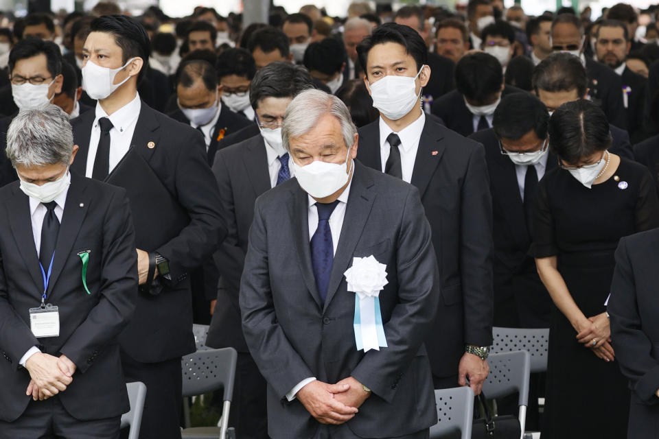 U.N. Secretary General Antonio Guterres, center, observes a minute of silence for the victims of the atomic bombing, at 8:15am, the time atomic bomb exploded over the city, during the ceremony marking the 77th anniversary of the atomic bombing at the Hiroshima Peace Memorial Park, in Hiroshima, western Japan Saturday, Aug. 6, 2022. (Kenzaburo Fukuhara/Kyodo News via AP)