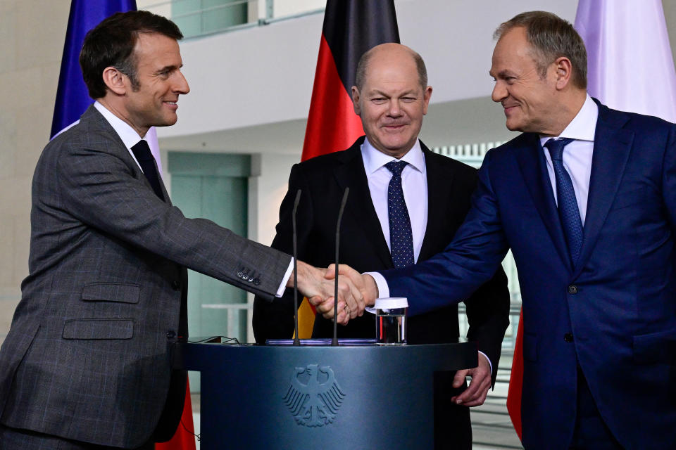 Emmanuel Macron schüttelt Hände mit Donald Tusk neben Olaf Scholz (Bild: Tobias SCHWARZ / AFP)