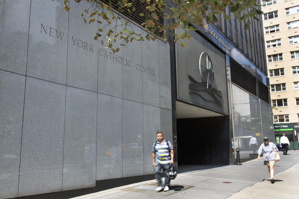 People pass the Archdiocese of New York, in New York, Thursday, Sept. 6, 2018. New York Attorney General Barbara Underwood subpoenaed all eight Roman Catholic dioceses in the state Thursday as part of a broadening civil investigation into the handling of sex abuse allegations by church leaders. (AP Photo/Richard Drew)