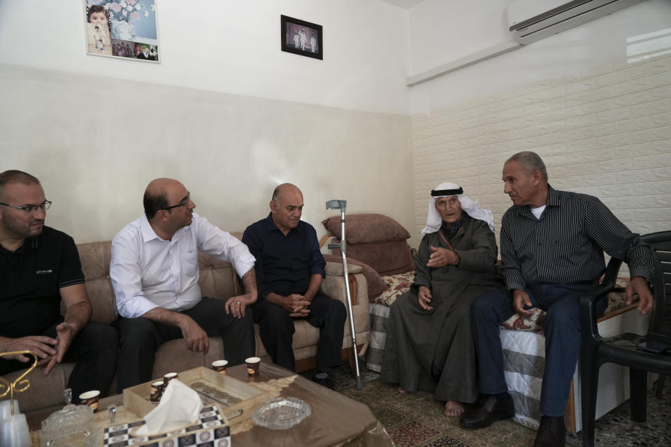 Sami Abu Shehadeh, 2nd from left, a member of the Knesset and the head of the nationalist Balad party, meet with Israel's Palestinian citizens during his election campaign tour in Musmus village, northern Israel, ahead of the upcoming elections, Friday, Oct. 21, 2022. Israel’s Palestinian citizens, a minority whose voice is often drowned out, delegitimized or disparaged in Israel’s noisy politics, could hold the key to breaking the country’s political deadlock. Israel heads to the polls Nov. 1 for the fifth time in less than four years. (AP Photo/Mahmoud Illean)