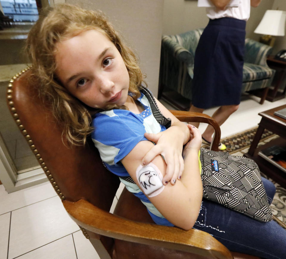 <p>Bella Nichols, 9, of Richland, Miss., shows where she wears her insulin patch that Medicaid helps pay for, as her mother and others meet with staff members of Sen. Thad Cochran in Jackson, Miss., Tuesday, June 29, 2017, while other recipients and their supporters stage a protest outside the offices. About 35 participants began the morning protesting the Senate version of the health care overhaul of the Affordable Healthcare Act, at Cochran’s office and by mid morning also carried the protest to the offices of Sen. Roger Wicker in the federal courthouse. (Photo: Rogelio V. Solis/AP) </p>