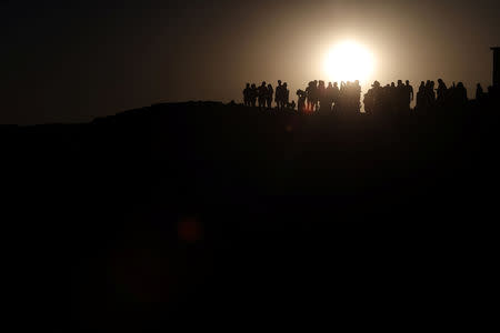 Tourists gather during the sunset at 'Valle de la Luna' (Moon Valley) in San Pedro de Atacama near the Atacama Salt Flat in the Atacama Desert, Chile August 16, 2018. Picture taken August 16, 2018. REUTERS/Ivan Alvarado
