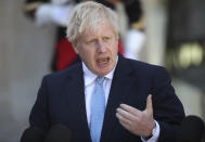 Britain's Prime Minister Boris Johnson gestures as he speaks to the media after being greeted by French President Emmanuel Macron at the Elysee Palace, Thursday, Aug. 22, 2019 in Paris. Boris Johnson traveled to Berlin Wednesday to meet with Chancellor Angela Merkel before heading to Paris to meet with French President Emmanuel Macron. (AP Photo/Daniel Cole)