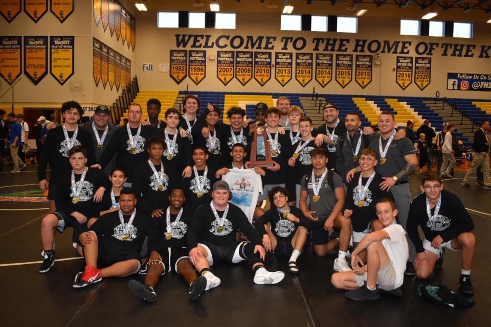 The Palmetto Ridge wrestling team celebrates winning thr 3A Dual State Championship in Kissimmee on January 22, 2022.