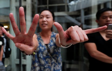 An anti-government protester gestures near pro-government supporters at Olympian City 2 shopping mall in Hong Kong