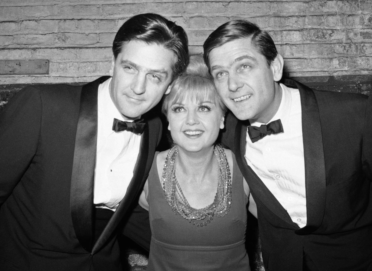 FILE - Angela Lansbury poses with her twin brothers Edgar, left, and Bruce backstage at the Belasco Theatre in New York in February 1966 after premier of "First One Asleep Whistle." Lansbury, the big-eyed, scene-stealing British actress who kicked up her heels in the Broadway musicals “Mame” and “Gypsy” and solved endless murders as crime novelist Jessica Fletcher in the long-running TV series “Murder, She Wrote,” died peacefully at her home in Los Angeles on Tuesday. She was 96. (AP Photo/Charles Harrity, File)