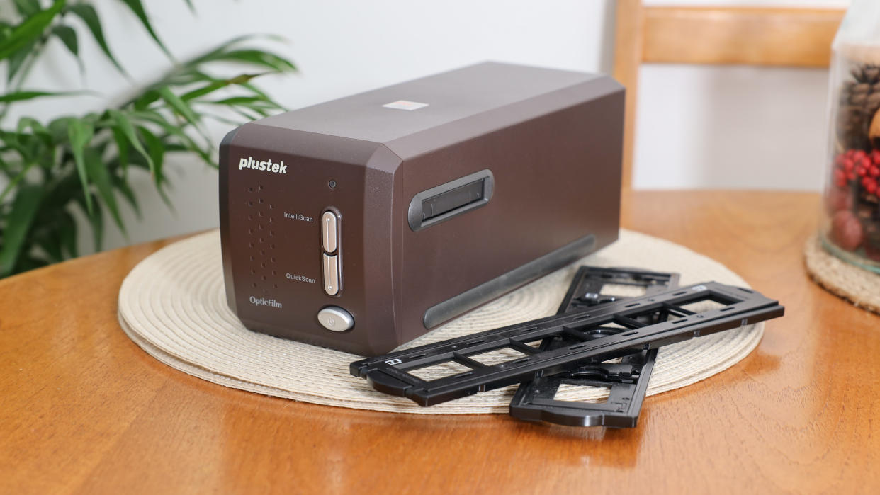  Plustek OpticFilm 35mm film scanner on a wooden table. 