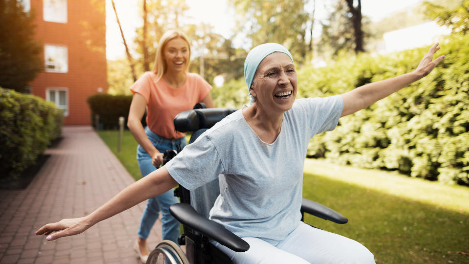 woman assisting a cancer patient in a nursing home