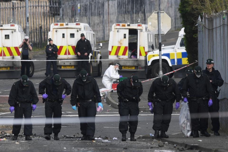 Police officers inspect the scene where the 29-year-old journalist Lyra McKee was shot dead, in Londonderry, Northern Ireland (REUTERS)