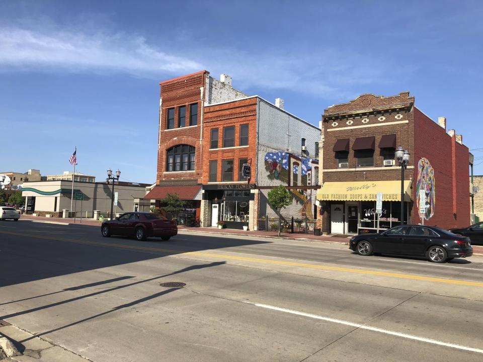 In this July 17, 2019, photo, cars drive down a street in downtown Saginaw, Michigan. The city has been working for decades to reinvent itself after the decline of the auto industry, with mixed results. President Donald Trump is campaigning on the improved economy as he seeks re-election, while Democrats argue not everyone has enjoyed the benefits. (AP Photo/Sara Burnett)