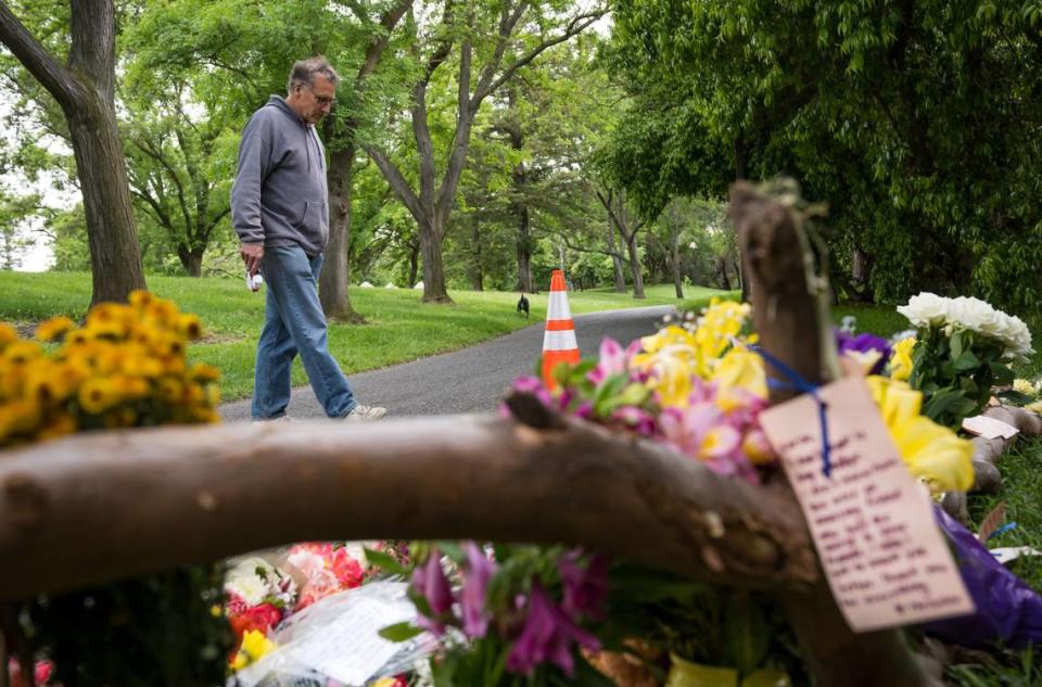 Michael Shearer, of Davis, stops while walking his dog Wednesday, May 3, 2023, to look at a memorial for Karim Abou Najm, who was found stabbed to death at Sycamore Park on April 29, in Davis. There have been three stabbings in the city in less than a week.