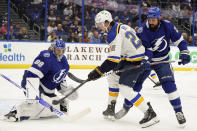 Tampa Bay Lightning goaltender Andrei Vasilevskiy (88) makes a stick save on a shot by St. Louis Blues center Logan Brown (22) during the first period of an NHL hockey game Thursday, Dec. 2, 2021, in Tampa, Fla. Looking on for the Lightning is defenseman Zach Bogosian (24). (AP Photo/Chris O'Meara)