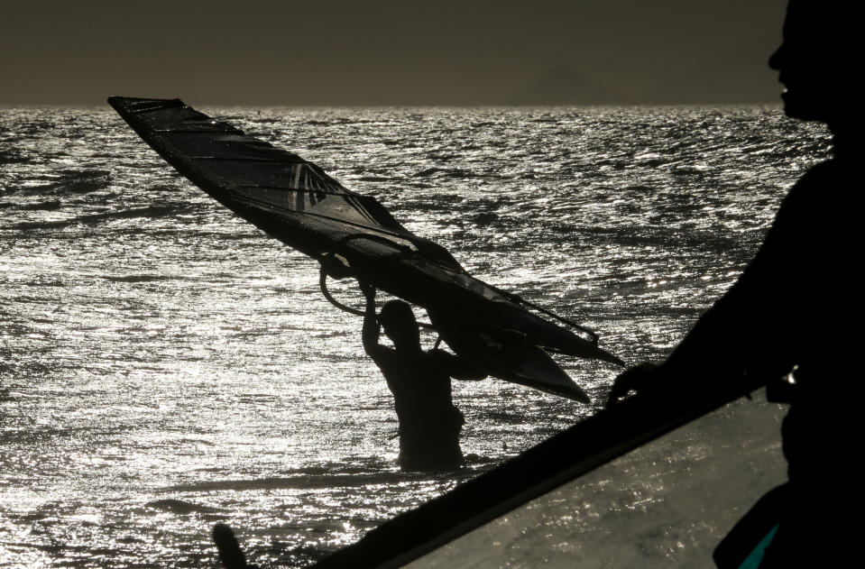 A windsurfer prepares to take on the waves