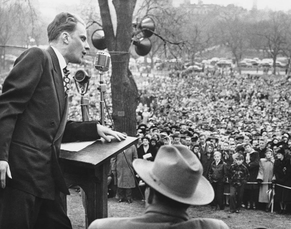 <p>The Rev. Billy Graham, crusading Evangelist, ended a tour of New England with a mass rally on historic Boston Common on April 23, 1950. Despite the cold weather, police estimated that 50,000 people attended the event. (Photo: AP) </p>