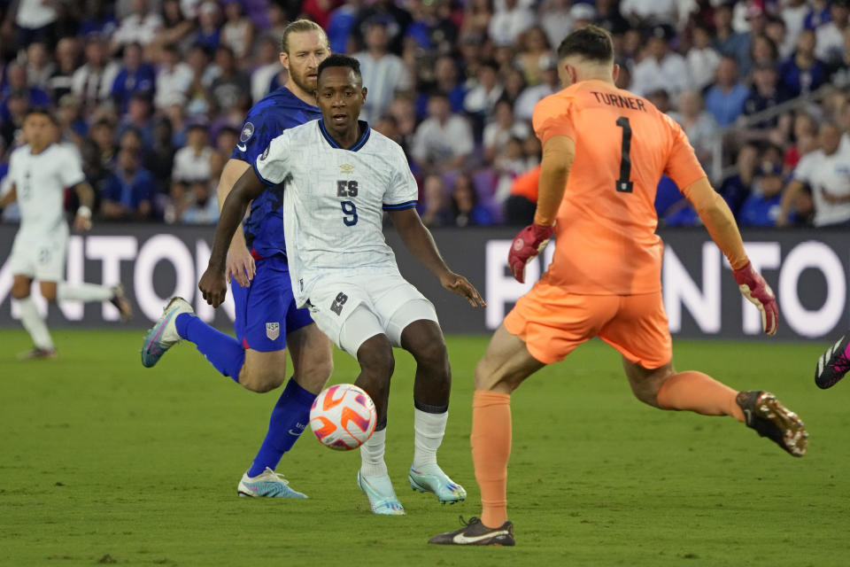 United States goalkeeper Matt Turner (1) clears the ball from his goal in front of El Salvador forward Bryan Gil (9) during the first half of a CONCACAF Nations League soccer match Monday, March 27, 2023, in Orlando, Fla. (AP Photo/John Raoux)