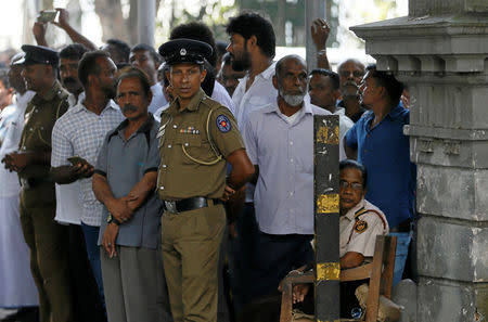 Sri Lanka's police officers stand guard as supporters wait outside the court for a decision after deposed Prime Minister Ranil Wickremesinghe-led United National Party's members filed a petition against President Maithripala Sirisena's decision to sack parliament, in Colombo, Sri Lanka November 13, 2018. REUTERS/Dinuka Liyanawatte