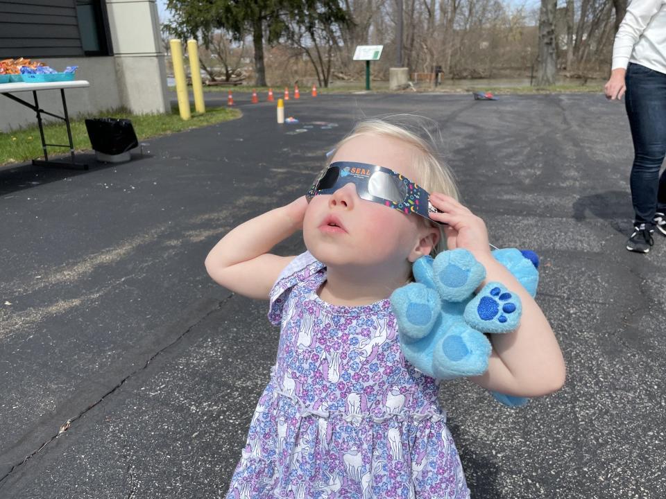 Alice McGovern, 2 1/2, tried out her eclipse glasses at Ellis Library & Reference Center.