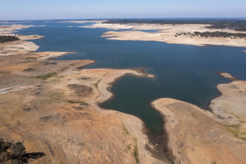 FOLSOM, CA - JULY 01: Dry lake bed is exposed as water levels recede at drought-stricken Folsom Lake, which stands XX% full, but the average for the date is XX% of average, reflecting the ongoing drought when this photograph was taken on Thursday, July 1, 2021 in Folsom, CA. (Brian van der Brug / Los Angeles Times)