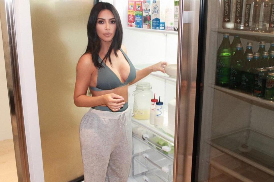 Kim Kardashian in SKIMS underwear by her fridge