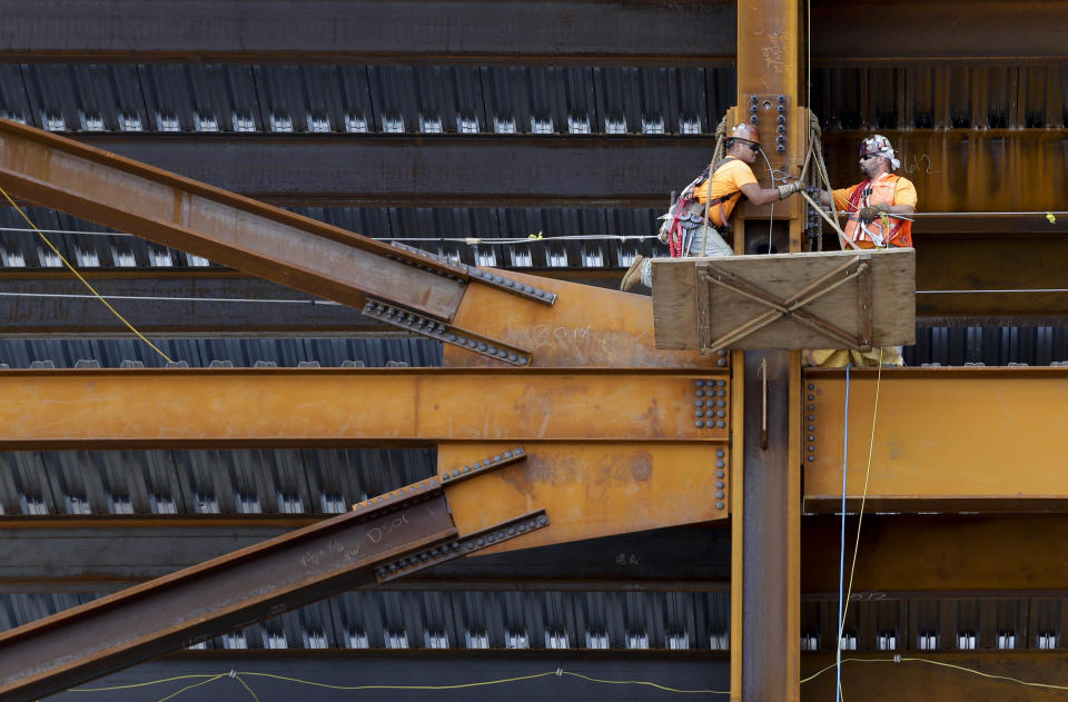 FILE - Construction workers work on a steel joint of the retail building at Hudson Yards, Thursday, Aug. 13, 2015, in New York. About 1 in 5 American workers, including retail and construction workers, are bound by noncompete agreements, according to the Federal Trade Commission. New York Gov. Kathy Hochul hasn't said whether she intends to sign state legislation passed last June that would ban noncompete agreements. The legislation has come under a fierce attack by business groups. (AP Photo/Julie Jacobson, File)
