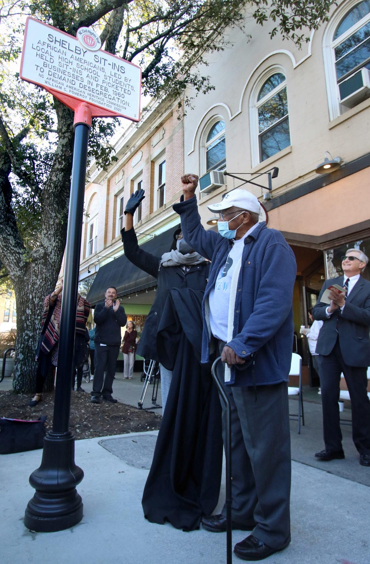 Lucretia Bell and Haywood Homsley celebrate after unveiling the marker during the NC Civil Rights Trail Marker Ceremony Saturday morning, Feb. 19, 2022, in front of the former Smith’s Drug Store in Shelby.