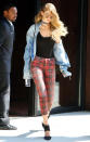 <p>The top model rocked a pair of red plaid skinny jeans with a black bodysuit and denim shirt in New York City.</p>