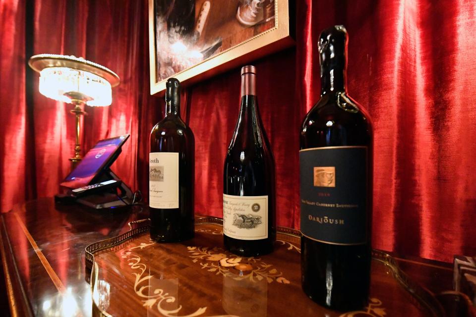 Bottles of wine sit on a table in The Ruby Room at Jeff Ruby's Steakhouse. The new Ruby Room is a private dining area with seating for 40, features a swagged ceiling, plush velvet booths and an oversized chandelier Friday, Aug. 25, 2023 in Louisville Ky.
